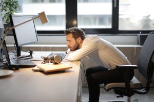 tired man working at computer