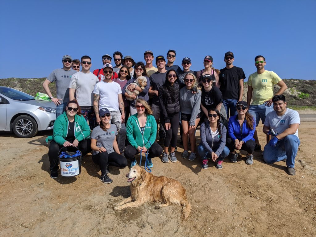 The Measurabl group stands and poses for a picture after cleaning up Fiesta Island in San Diego, CA.